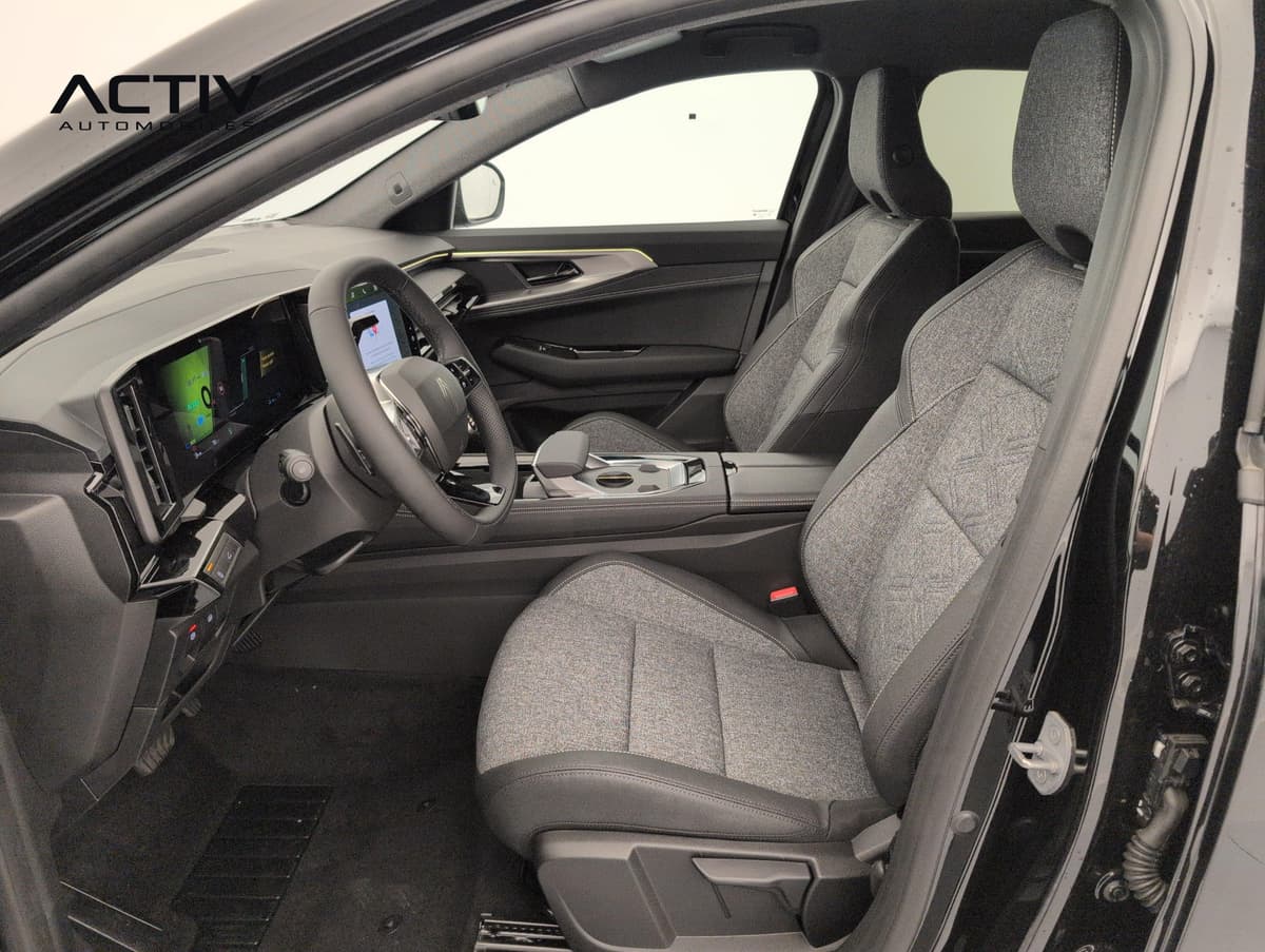 Renault Austral : sièges avant en tissu gris chiné et poste de conduite vus par la portière