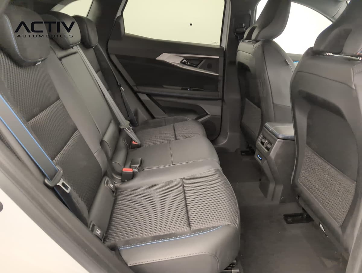 Renault Austral : banquette arrière en tissu noir avec surpiqûres bleues, vue par la portière ouverte