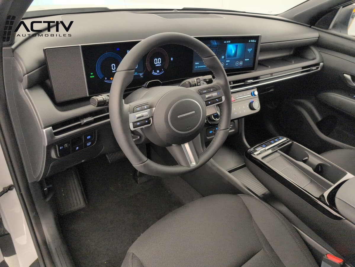 Hyundai Tucson : habitacle avant côté conducteur avec volant, écran large et console centrale