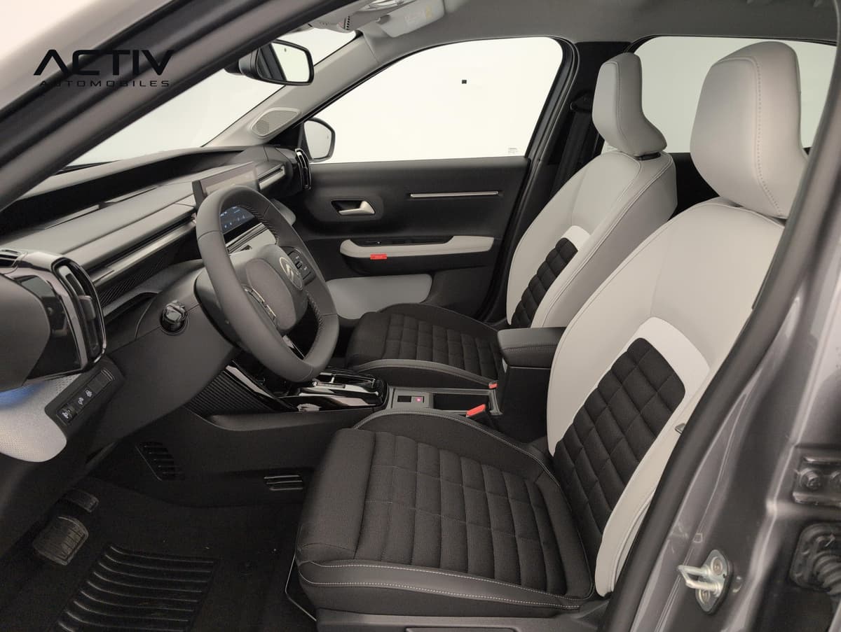 Citroën C3 Aircross : sièges avant bicolores noir et gris clair vus depuis la portière conducteur ouverte
