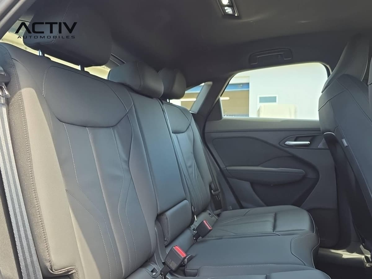 Audi Q3 Sportback Hybride : banquette arrière noire avec surpiqûres claires vue depuis la portière ouverte