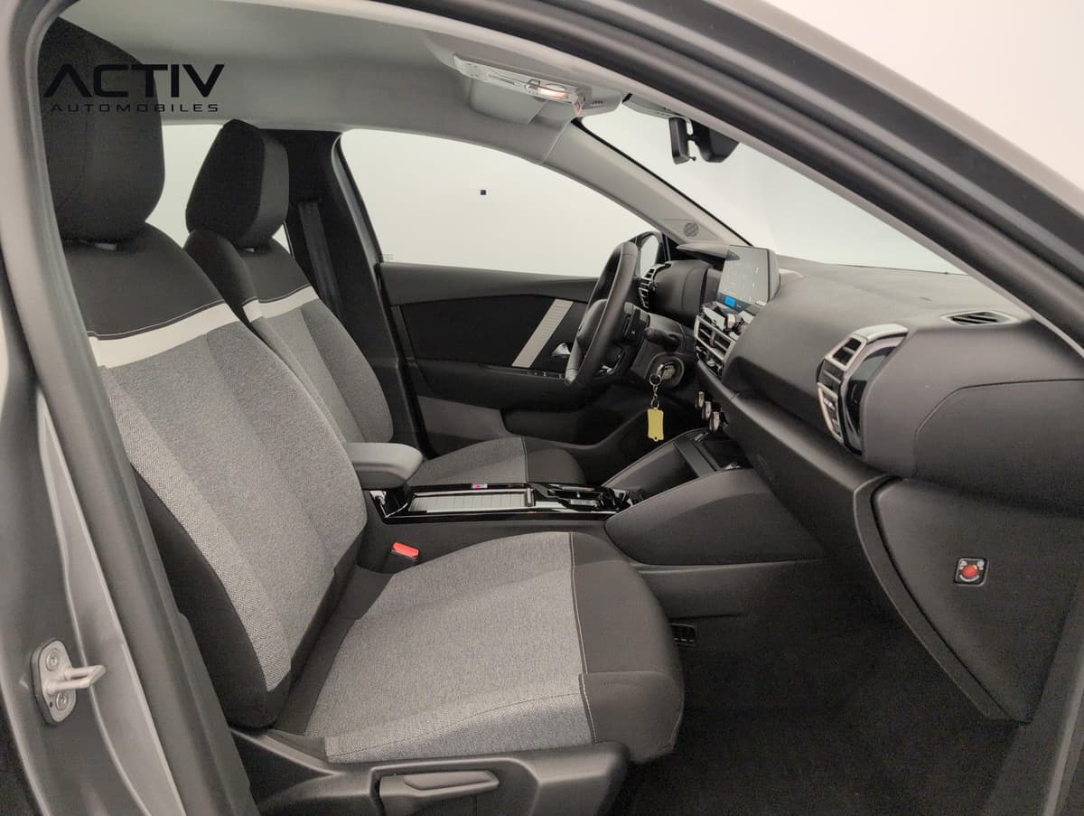 Citroën C4 : sièges avant en tissu gris et noir vus par la portière passager ouverte