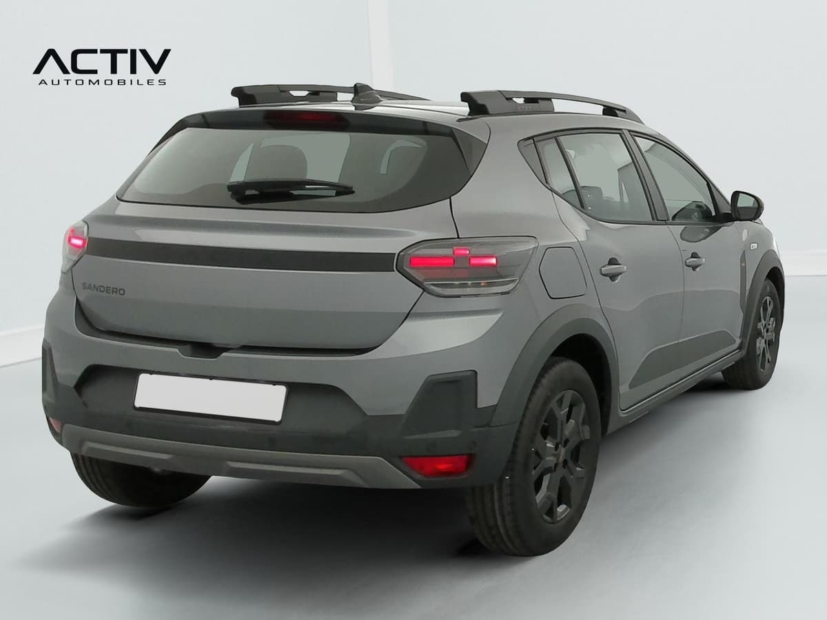 Dacia Sandero Gpl : vue arrière trois quarts droit avec barres de toit et jantes alliage sombres